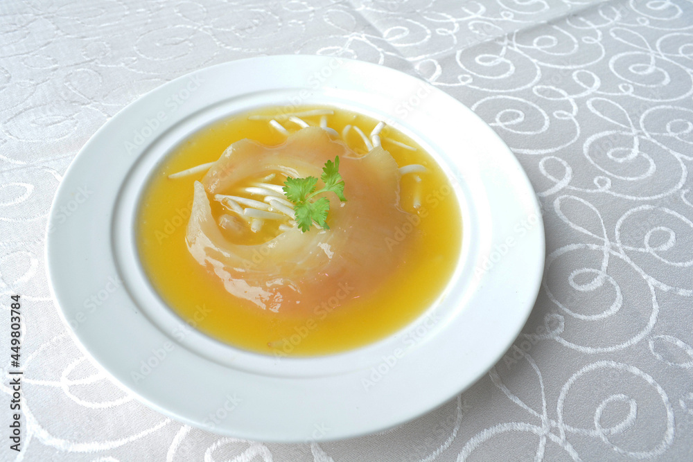 braised superior whole shark's fin thick soup with golden stock seafood in white background asian halal menu braised superior whole shark's fin thick soup with golden stock seafood in white background asian halal menu