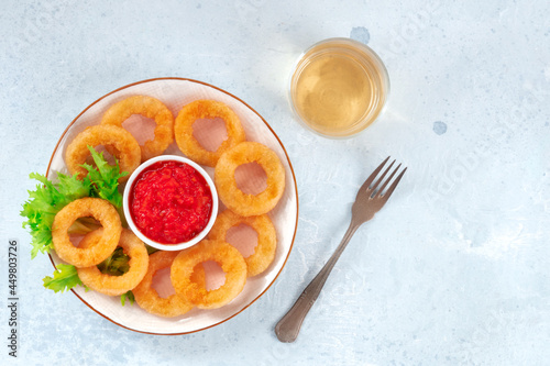Squid rings. Deep fried calamari rings with ketchup, lettuce, and white wine, top shot with a place for text