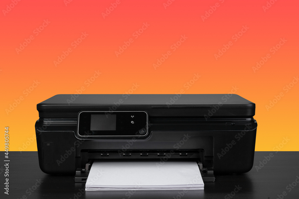 Compact home laser printer against orange background Compact home laser printer against orange background