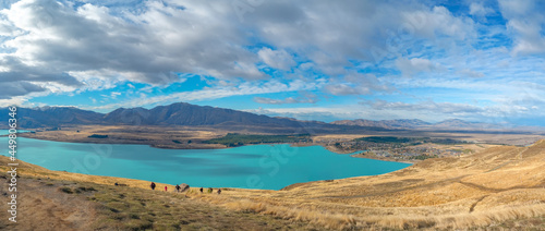 aerial view of a turquoise Lake Tekapo and a lovely Tekapo Town in Autumn, view from Mount John in Mackenzie Region, south island of New Zealand