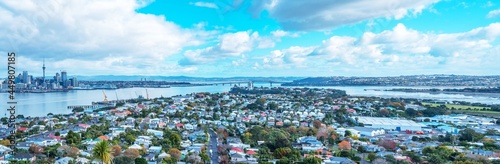 stunning skyline view of Auckland cityscape with Auckland Harbour bridge at the far end, photo taken from Mount Vitoria lookout view point located in seaside village of Devonport