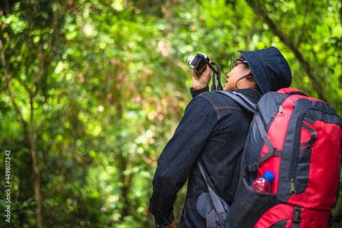 Tourists photograph wildlife and the beauty of nature in the tropical forest in Khao Yai National Park, Thailand. Bird, hornbill And Monkey watching tour. Image of the concept of eco-tourism.