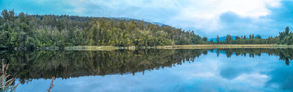 Lake Matheson nearby Franz Josef Glacier located in West Coast of Island New Zealand. A perfect scenery of mirror reflection of Mount Cook and Mount Tasman Lake Matheson nearby Franz Josef Glacier located in West Coast of Island New Zealand. A perfect scenery of mirror reflection of Mount Cook and Mount Tasman