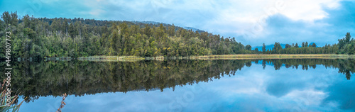 Lake Matheson nearby Franz Josef Glacier located in West Coast of Island New Zealand. A perfect scenery of mirror reflection of Mount Cook and Mount Tasman