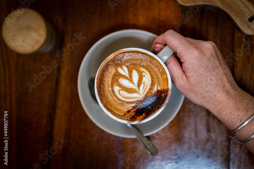 Making a beautiful coffee, with chocolate on the top, in a café in Australia. photo