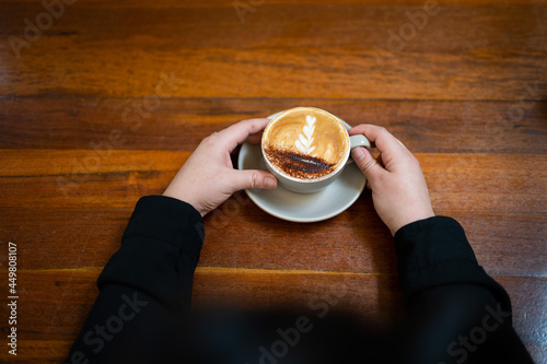 Making a beautiful coffee, with chocolate on the top, in a café in Australia. photo