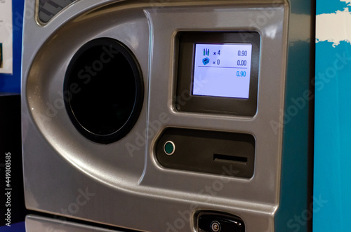 A reverse vending machine is a device that accepts used (empty) beverage containers and returns money to the user. photo