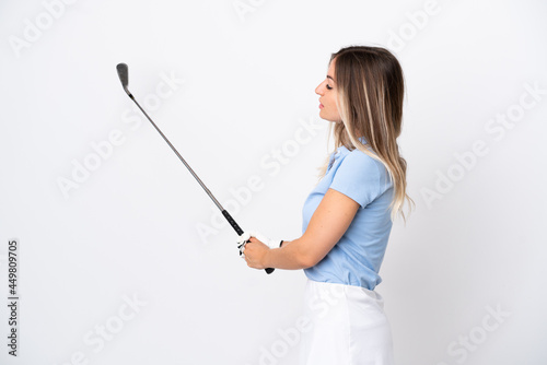 Young Romanian woman isolated on white background playing golf