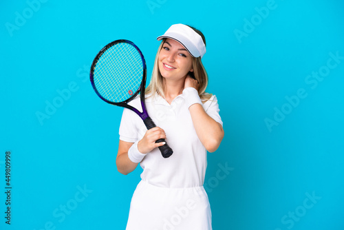 Young tennis player Romanian woman isolated on blue background laughing © luismolinero