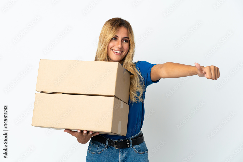 Young blonde Uruguayan delivery woman isolated on white background giving a thumbs up gesture Young blonde Uruguayan delivery woman isolated on white background giving a thumbs up gesture