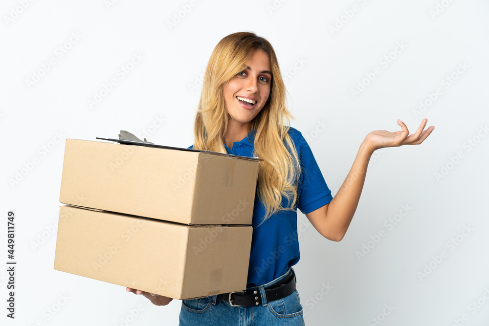Young blonde Uruguayan delivery woman isolated on white background extending hands to the side for inviting to come Young blonde Uruguayan delivery woman isolated on white background extending hands to the side for inviting to come