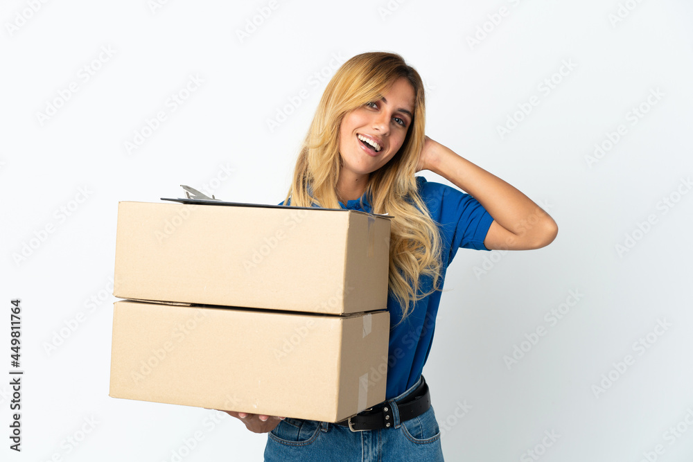 Young blonde Uruguayan delivery woman isolated on white background laughing Young blonde Uruguayan delivery woman isolated on white background laughing