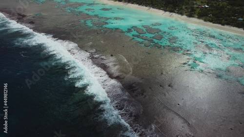 aerial tilt up revealing breathtaking beach and turquoise water at Yejele beach, Maré Island photo