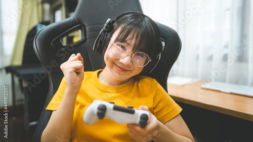 Young adult asian gamer woman wear eyeglasses play a online game.