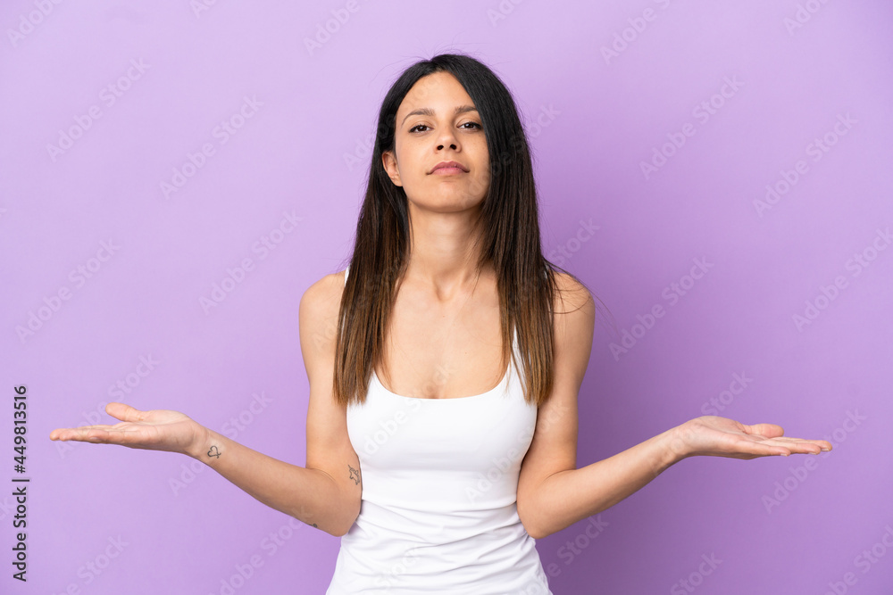 Young caucasian woman isolated on purple background having doubts Young caucasian woman isolated on purple background having doubts