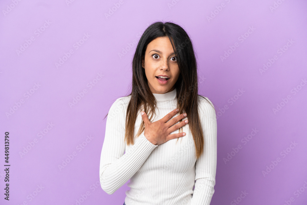 Young caucasian woman isolated on purple background surprised and shocked while looking right Young caucasian woman isolated on purple background surprised and shocked while looking right