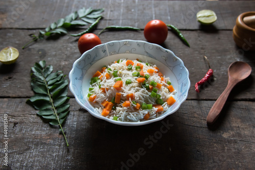 Vegetable pulao or flavoured rice mix with vegetables served in a bowl. Close up.