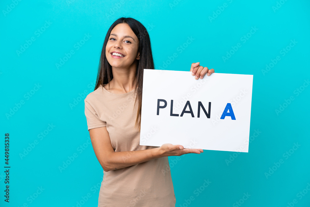 Young woman over isolated background holding a placard with the message PLAN A with happy expression Young woman over isolated background holding a placard with the message PLAN A with happy expression