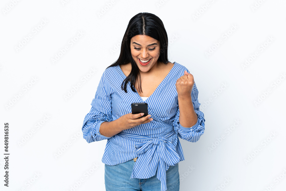 Young latin woman woman isolated on white background surprised and sending a message Young latin woman woman isolated on white background surprised and sending a message