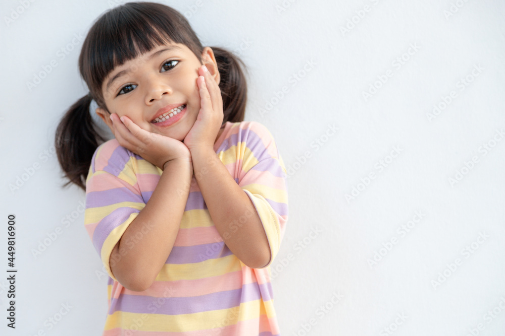 Portrait of happy smiling child girl isolated on white background