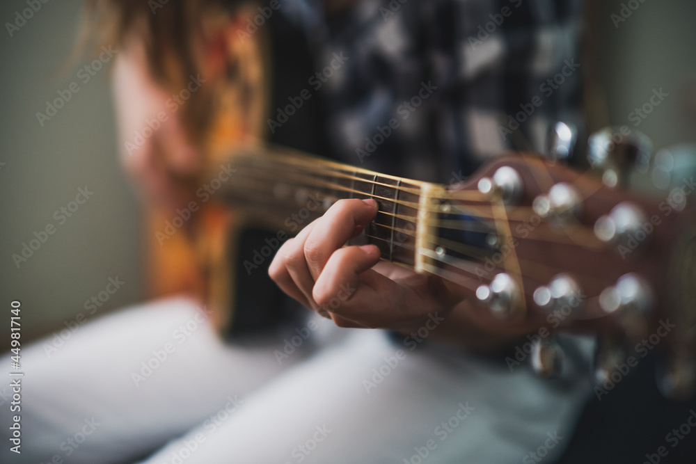 Teenage girl is playing guitar at home. Teenage girl is playing guitar at home.