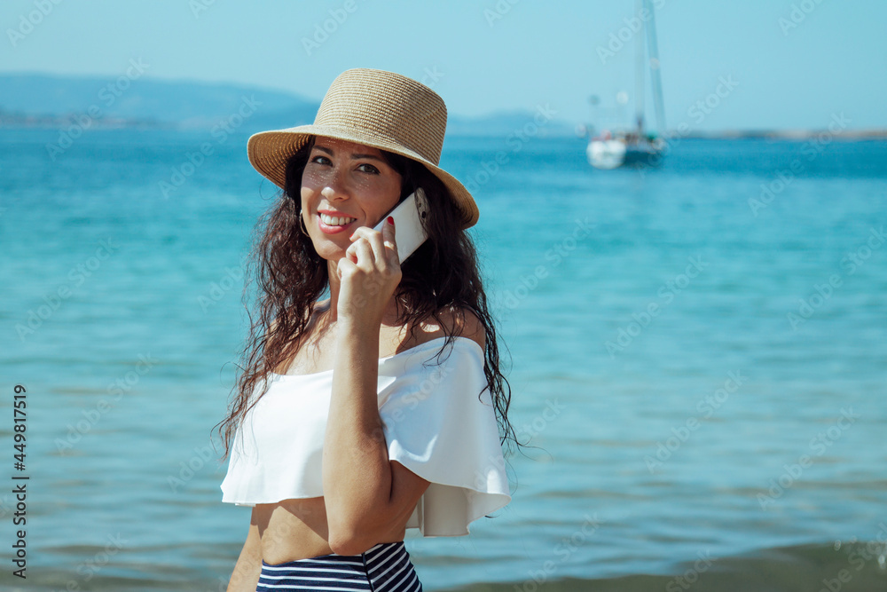 woman on the beach talking with the mobile phone