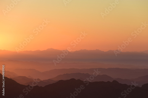 Colorful sunrise in mountains. © Kuzmick