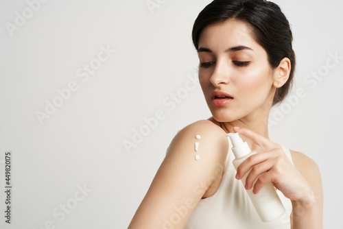 woman with jar of cream apply on hand close-up health