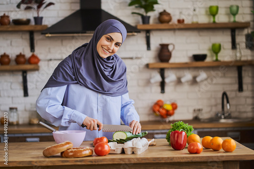 Arabian woman cooking a vegetarian meal with fresh vegetables