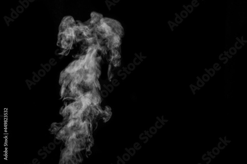 Perfect mystical curly white steam or smoke isolated on black background. Abstract background fog or smog