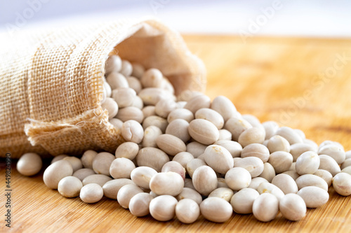 Raw Organic White Haricot bean on wooden background photo