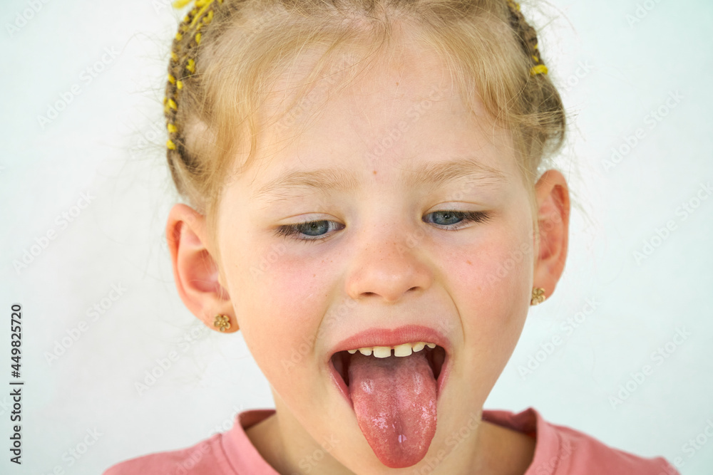 Cheerful child. Girl laughs close-up of the face on a white background