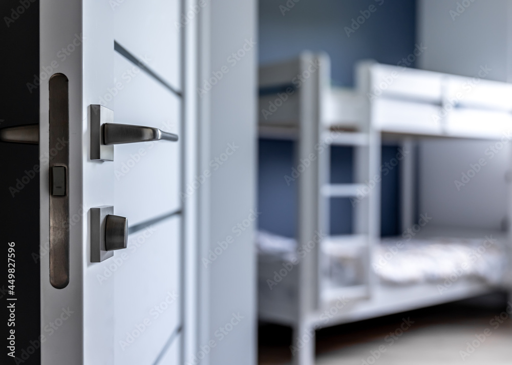 Close-up of metal doorknob on blurred background of home interior. Close-up of metal doorknob on blurred background of home interior.