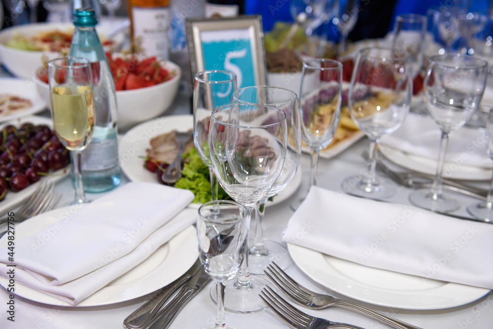 A table with dishes of food for the reception of guests. Festive eating at a banquet party.