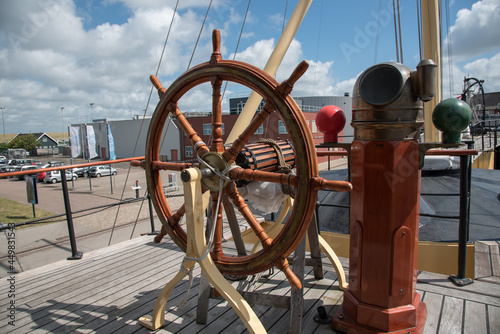Den Helder, the Netherlands. August 2021. Rudder and compass of an old warship in the harbor of Den Helder.