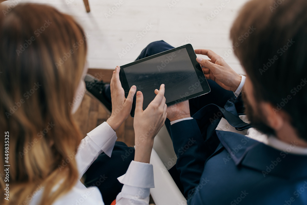 man and woman in business suits work with a tablet managers professionals