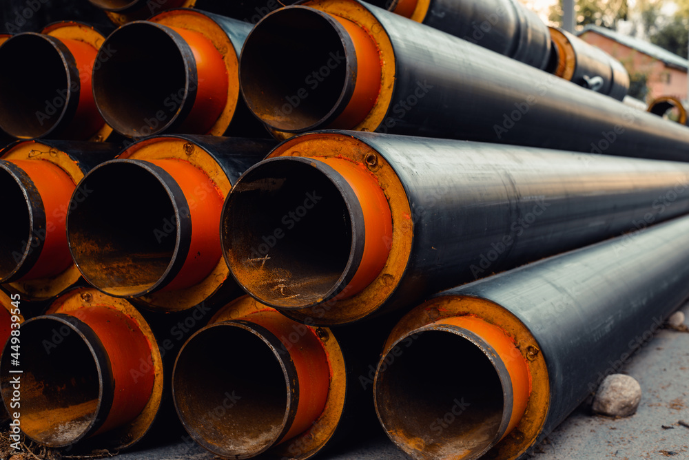 Group of objects new metal industrial pipes for water outside, pipeline for urban construction, sewage or heat supply. Selective focus in the foreground. Group of objects new metal industrial pipes for water outside, pipeline for urban construction, sewage or heat supply. Selective focus in the foreground.