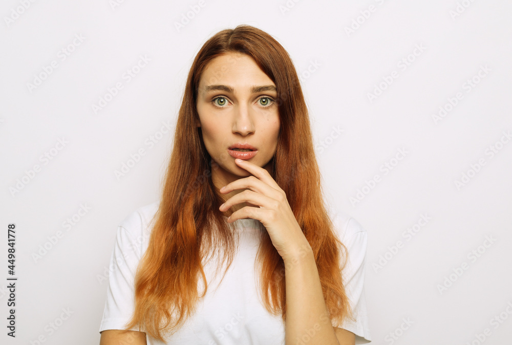 A young woman looks scared, worried, surprised or upset. A young woman looks scared, worried, surprised or upset.