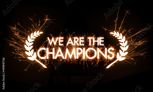 We Are The Champions banner title framed by garland in sparker effect on dark background. photo