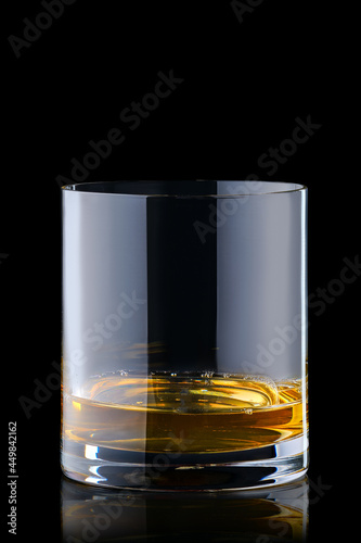 Obraz na plátne Portion of bourbon in transperent glass isolated on black