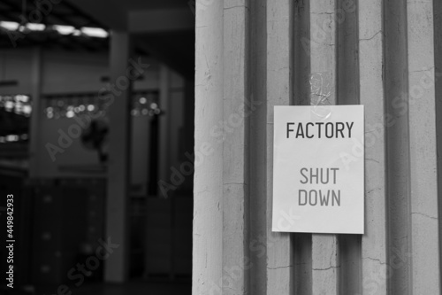 Factory Shut Down sign in front of the factory warehouse. Business shutdown because of economic recession and Coronavirus Covid-19.