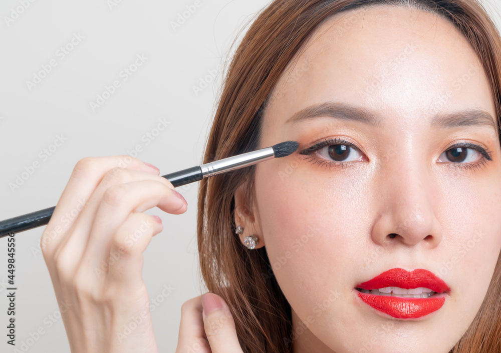 portrait beautiful woman with makeup eye brush