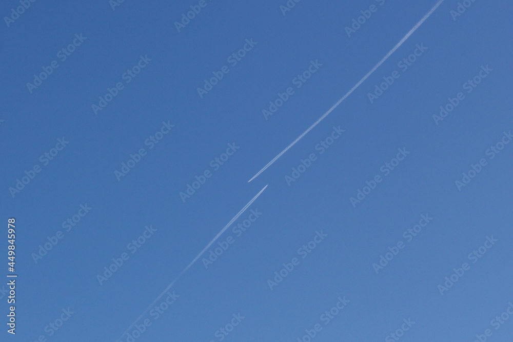 Clear blue sky with condensation trail of plane Clear blue sky with condensation trail of plane