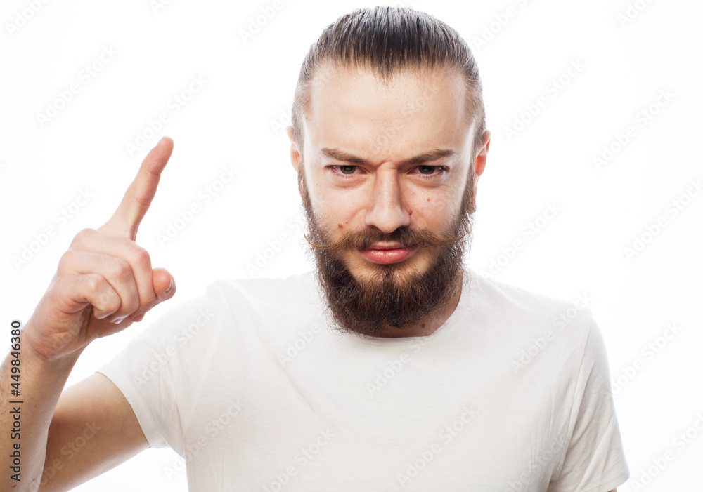 Emotional and people concept: young bearded man wearing white t-shirt with good idea sign Emotional and people concept: young bearded man wearing white t-shirt with good idea sign