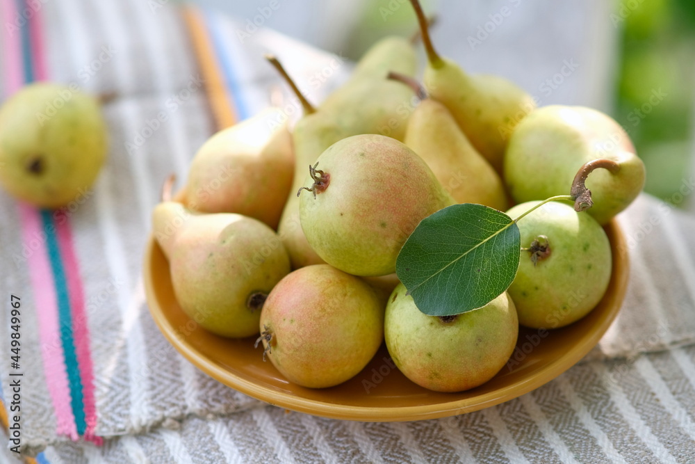 Yellow nrushi in a yellow plate. Still life of ripe pears. Fruit in a bowl