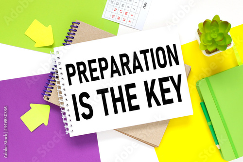 PREPARATION IS THE KEY. notepad on a colorful background. white purple and yellow background. photo