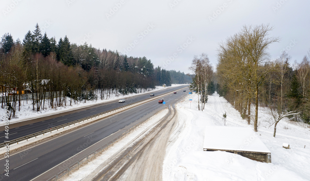 Aerial bird-eye view on freeway road in the winter forest. Aerial bird-eye view on freeway road in the winter forest.