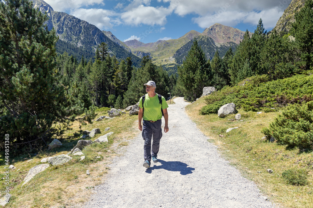 Middle aged caucasian tourist man walking on the Spanish Pyrenees Mountain
