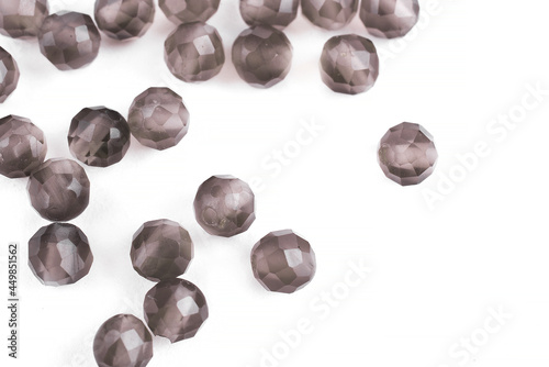 Beads made of natural rauchtopaz agate on a white background are isolated