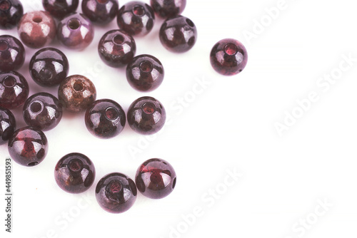 Beads made of natural garnet agate on a white background are isolated